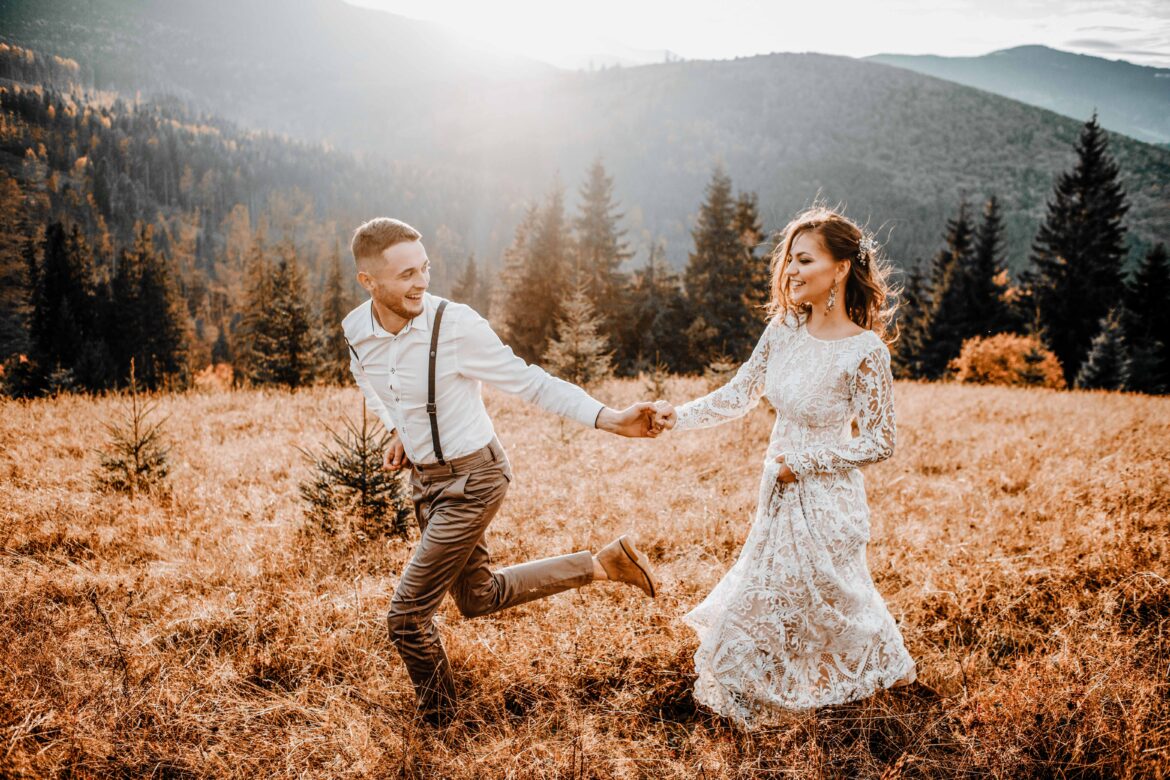Gatlinburg Wedding Venues Sunset illuminates mountain hill where wedding couple walks
